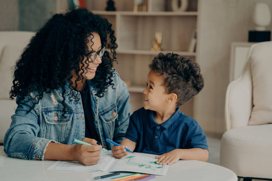 Mother and son enjoying indoor colouring activities together during the February half-term holiday