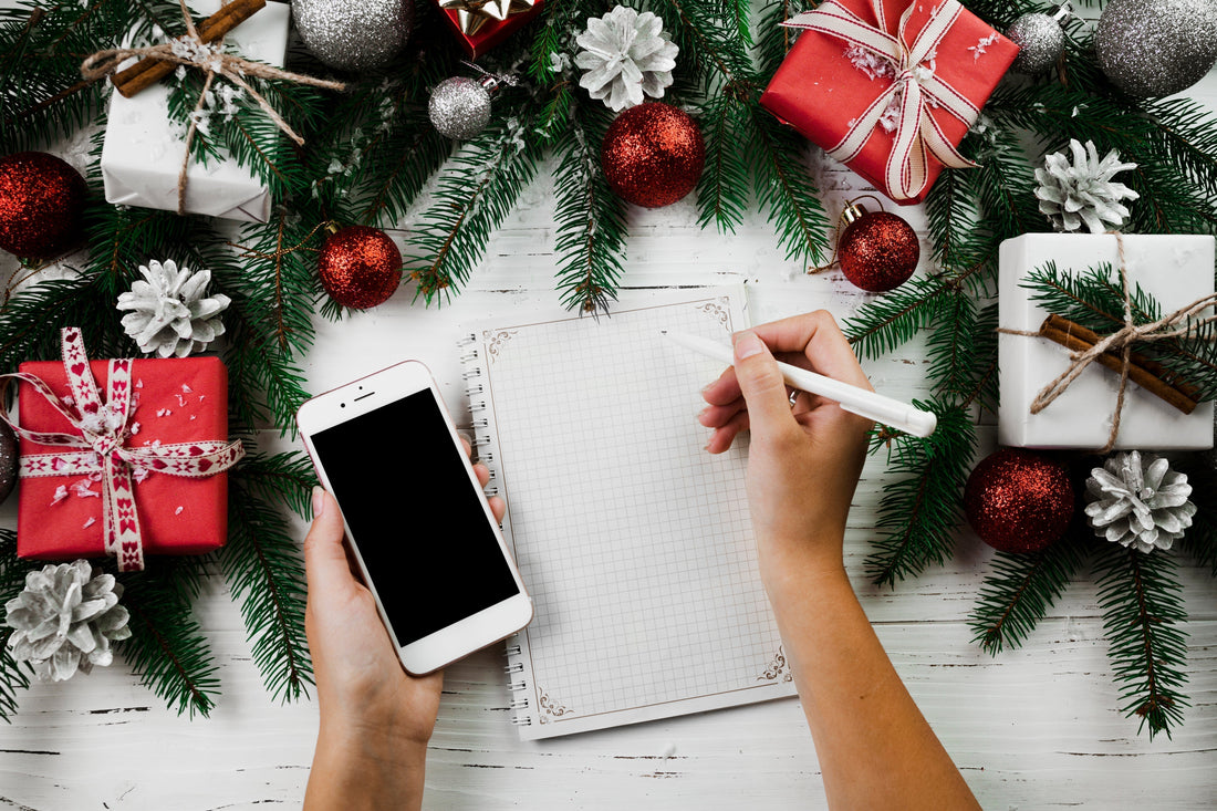 Photo showing gifts and a note pad, representing Christmas 2025 planning