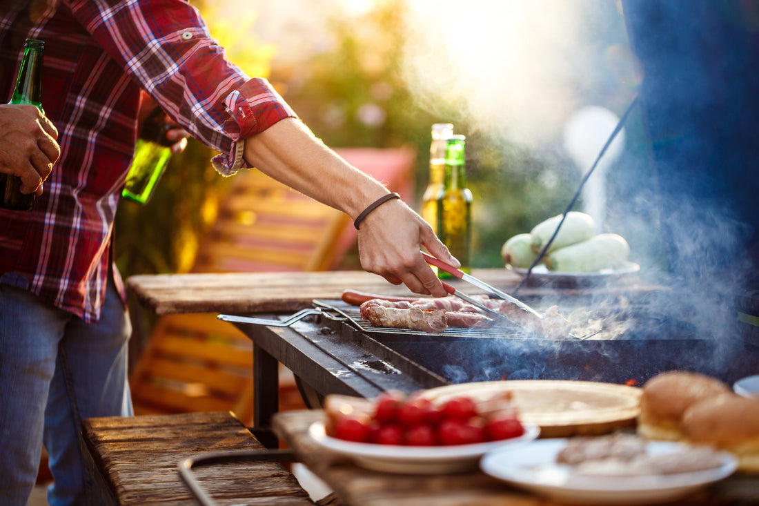 Spring BBQ setup in a sunny UK garden with marinated chicken skewers, gourmet snacks, and refreshing drinks.