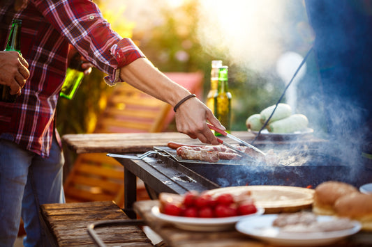 Spring BBQ setup in a sunny UK garden with marinated chicken skewers, gourmet snacks, and refreshing drinks.