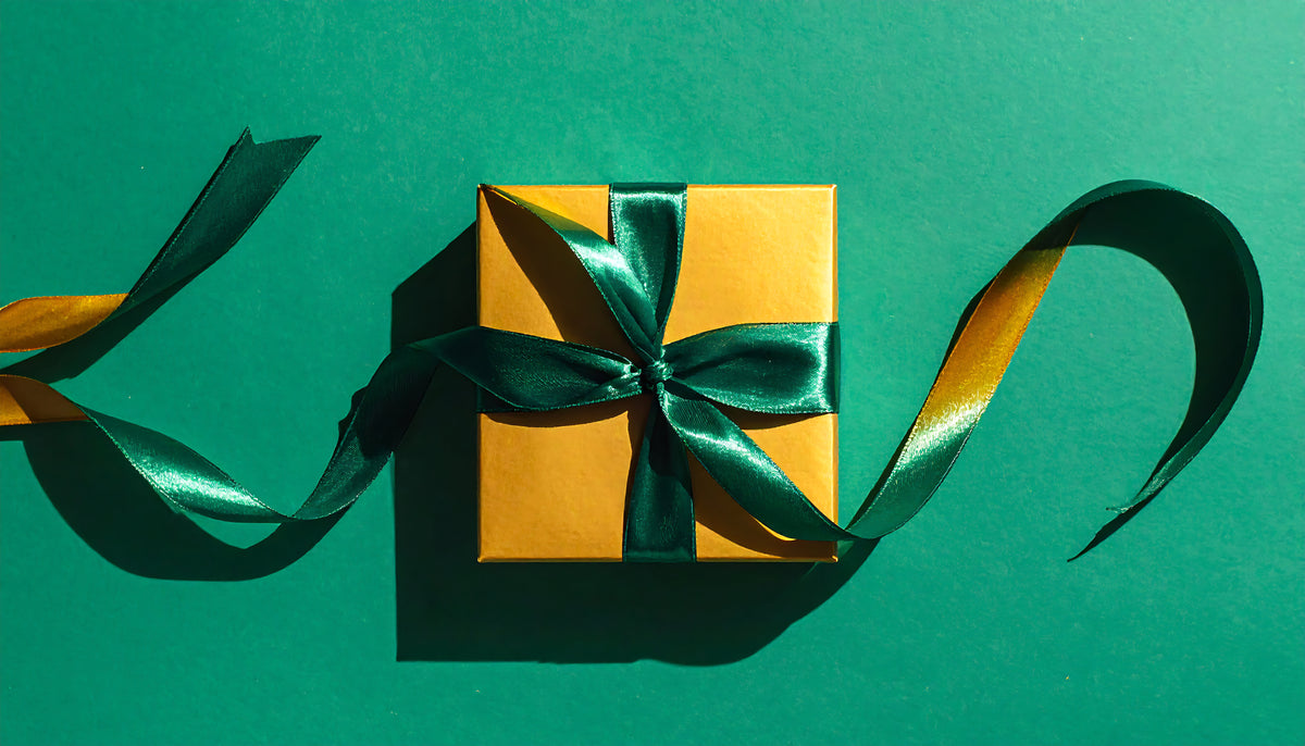 gift-box-with-green-ribbon-on-green-backdrop