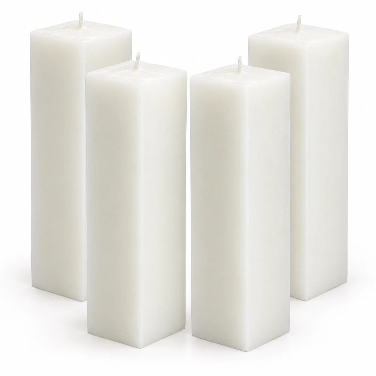 Four white rectangular pillar candles arranged in a group on a clean white background.